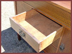 The upper middle drawer open showing the original "ooze leather" covering the interior.